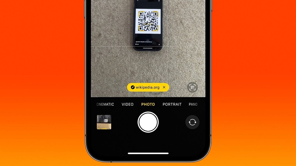 orange mobile phone or smartphone with barcode, qr code scanning